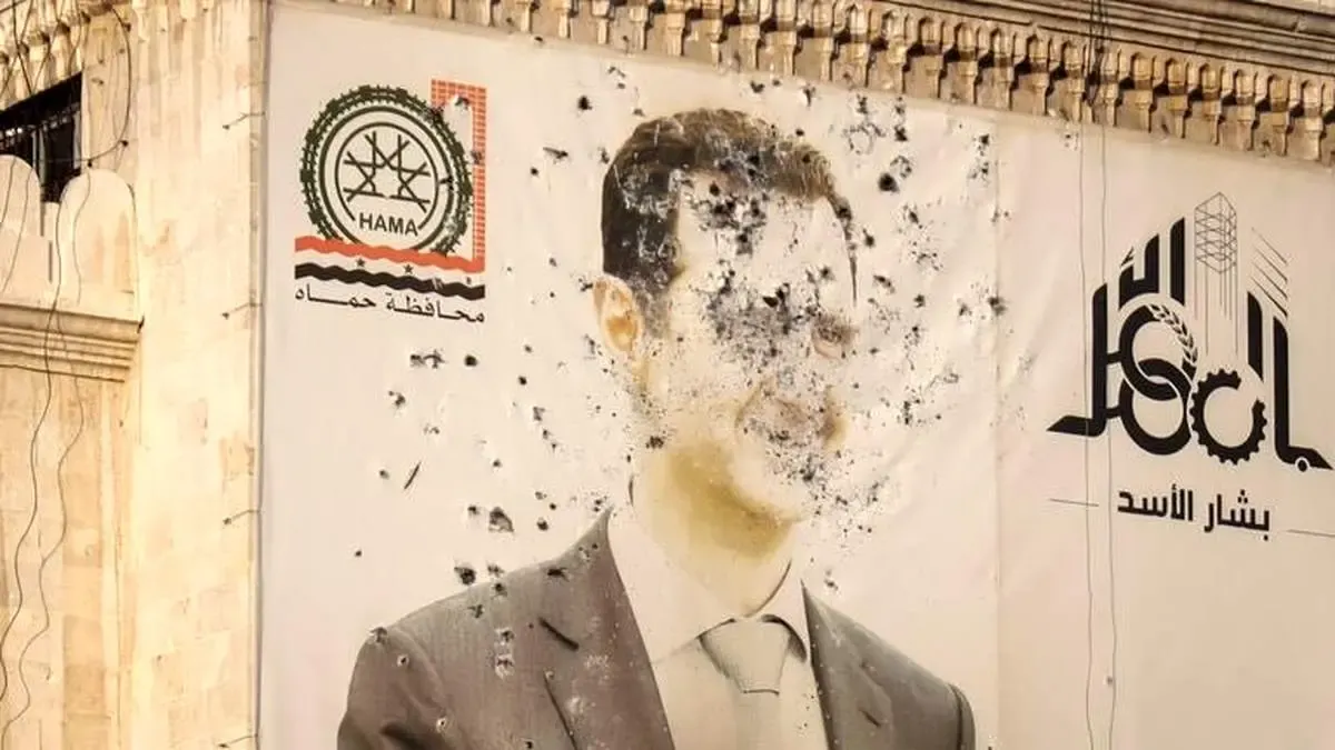 تخریب تصویر بشار اسد در دمشق/ عکس